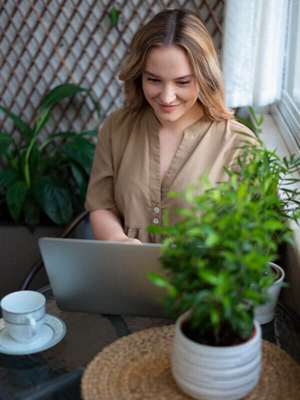 A woman managing her money on a laptop at home