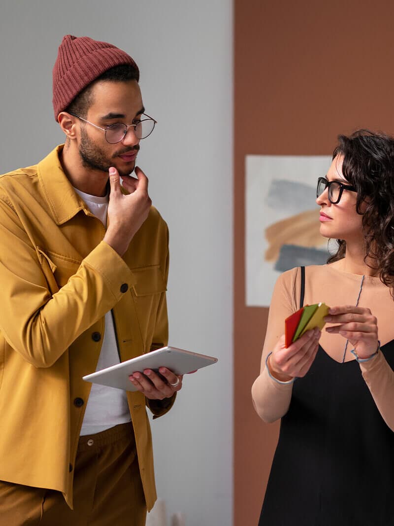 Two small business owners reviewing plans in their studio