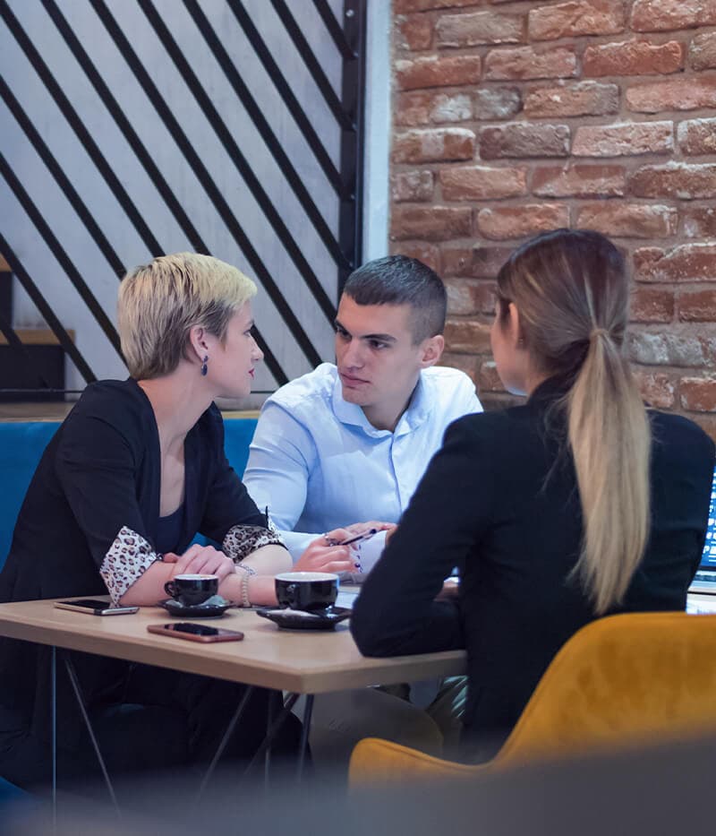 Colleagues discussing ideas around a table
